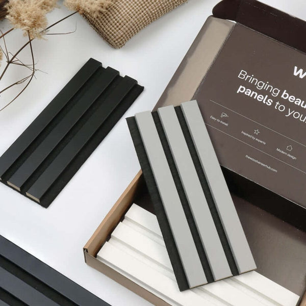 Acupanel coloured range sample box open displaying black, grey and white slat panel samples with branded WVH packaging