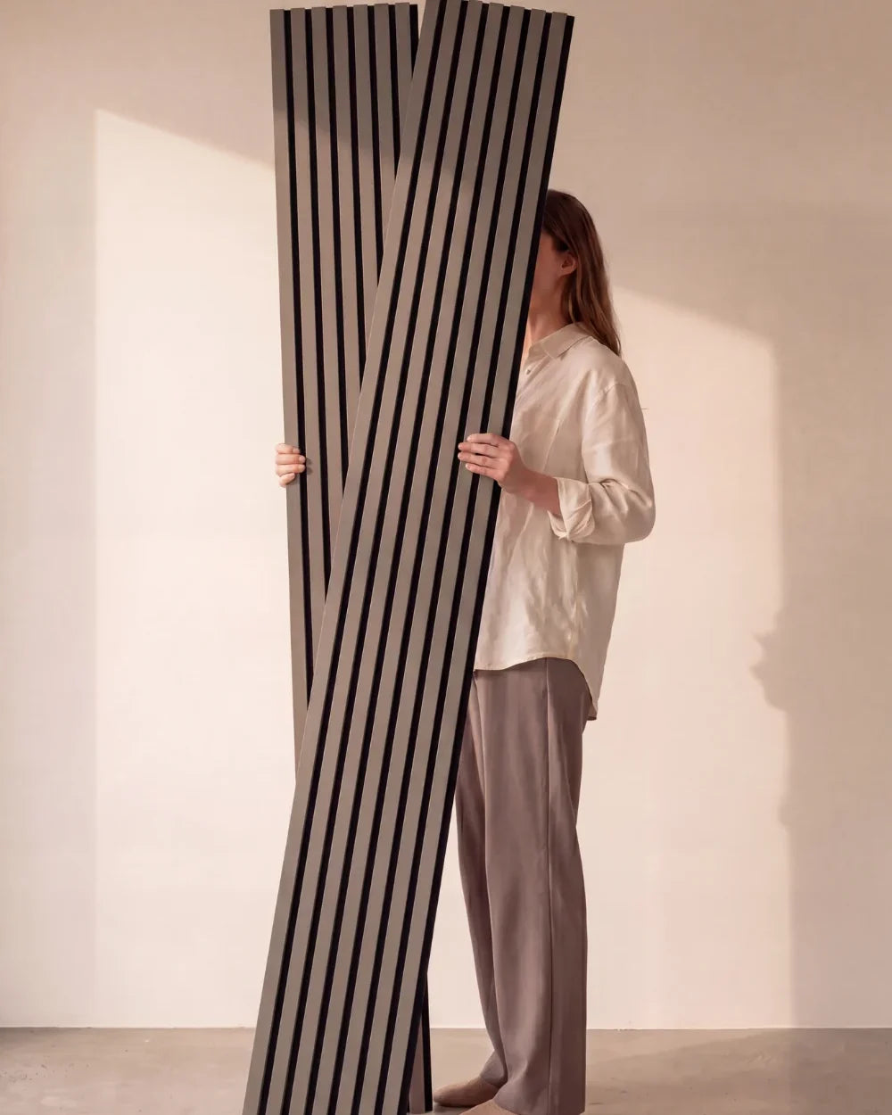 Acupanel Dusty Grey acoustic slat wall panels held in the studio
