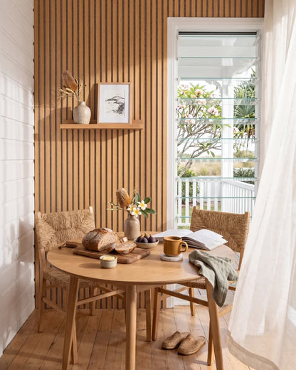 Acupanel Natural Oak (Grey Felt) acoustic slat wall panels in a sun room breakfast area