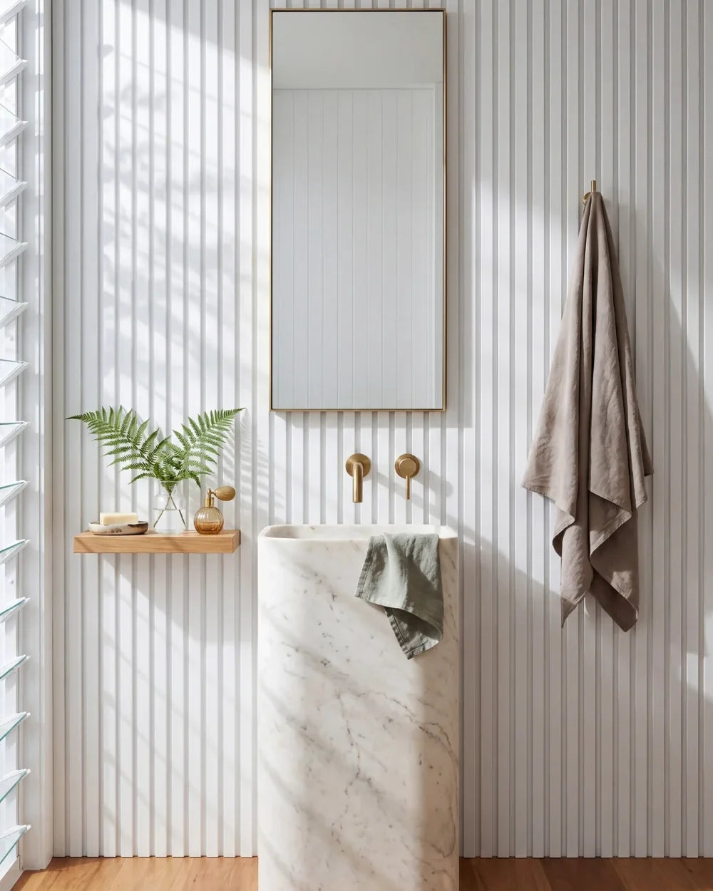 Acupanel White acoustic slat wall panels in a powder room