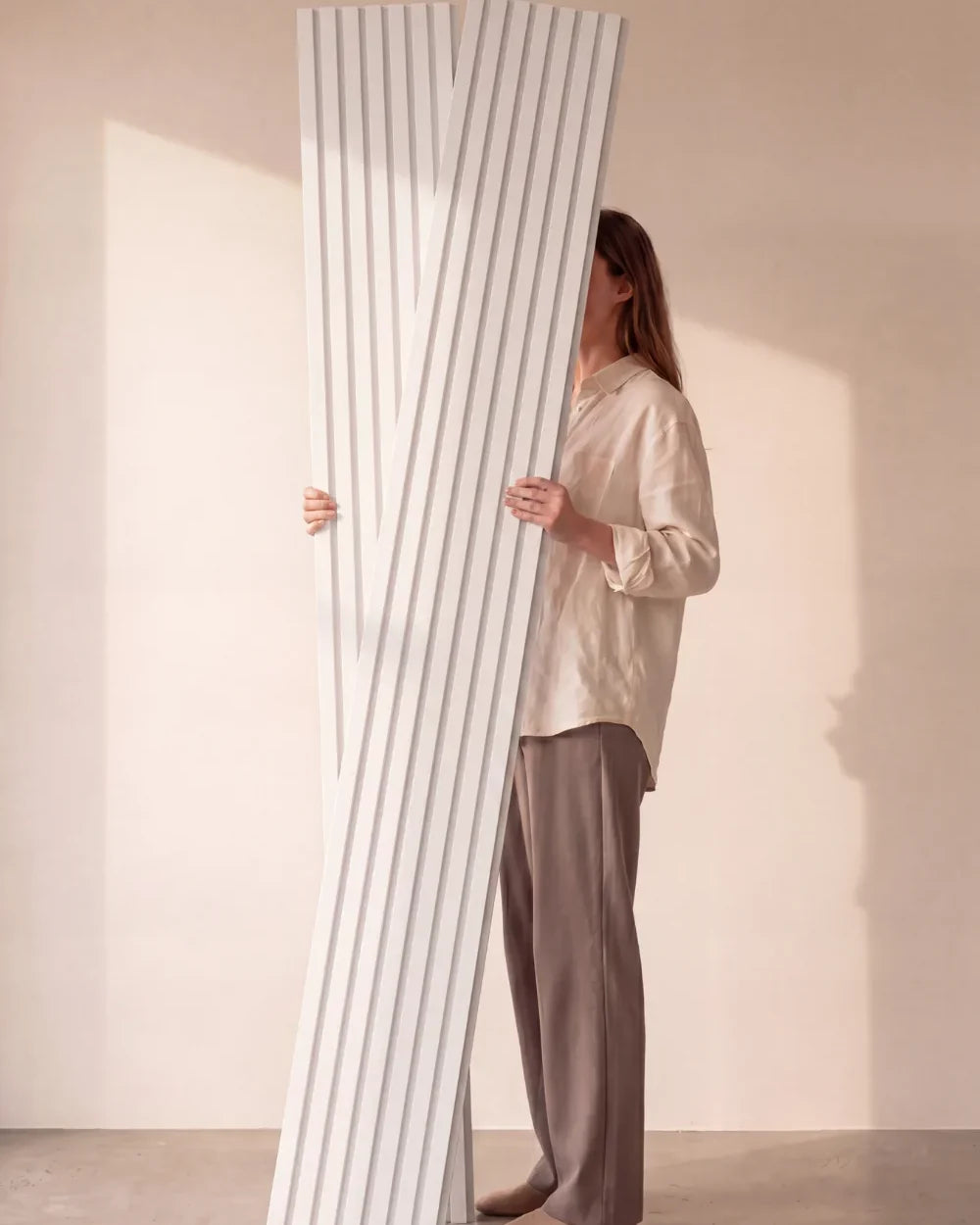 Acupanel White acoustic slat wall panels held in the studio