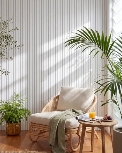 Acupanel White acoustic slat wall panels in a sunny reading nook