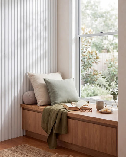 Acupanel White acoustic slat wall panels behind a window seat